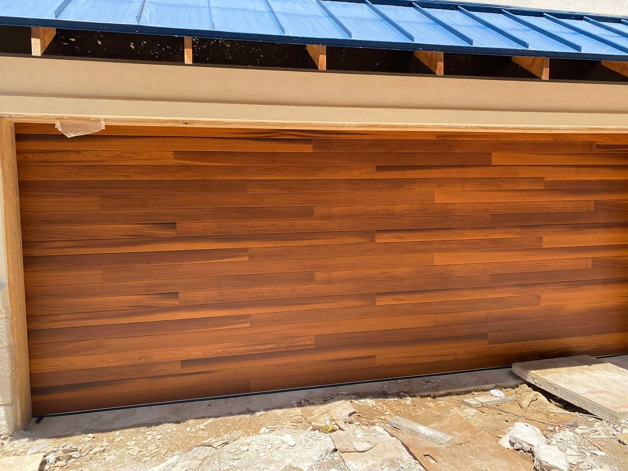Carriage-style garage door installed by Door Pro Plus on a Texas Hill Country home