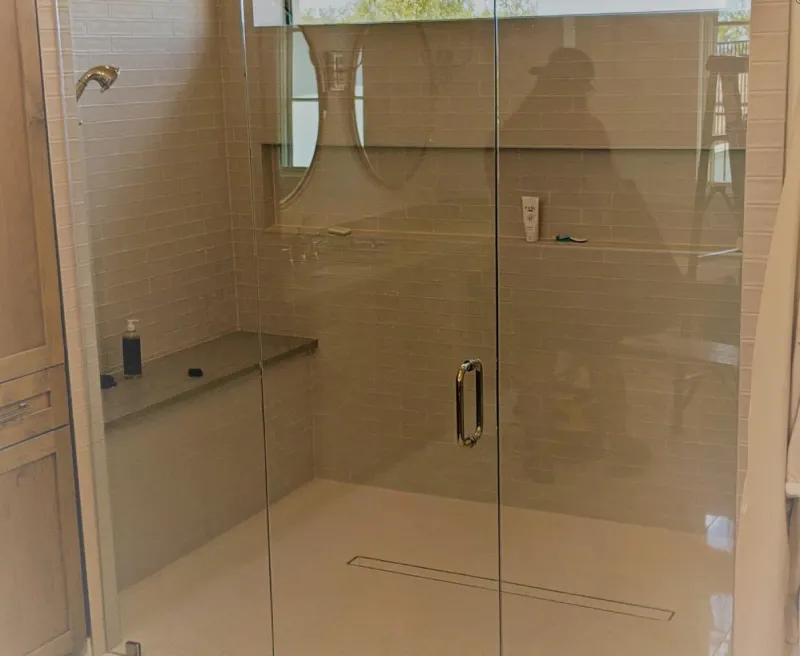 Custom frameless glass shower enclosure with tile surround installed by Door Pro Plus in Marble Falls, TX