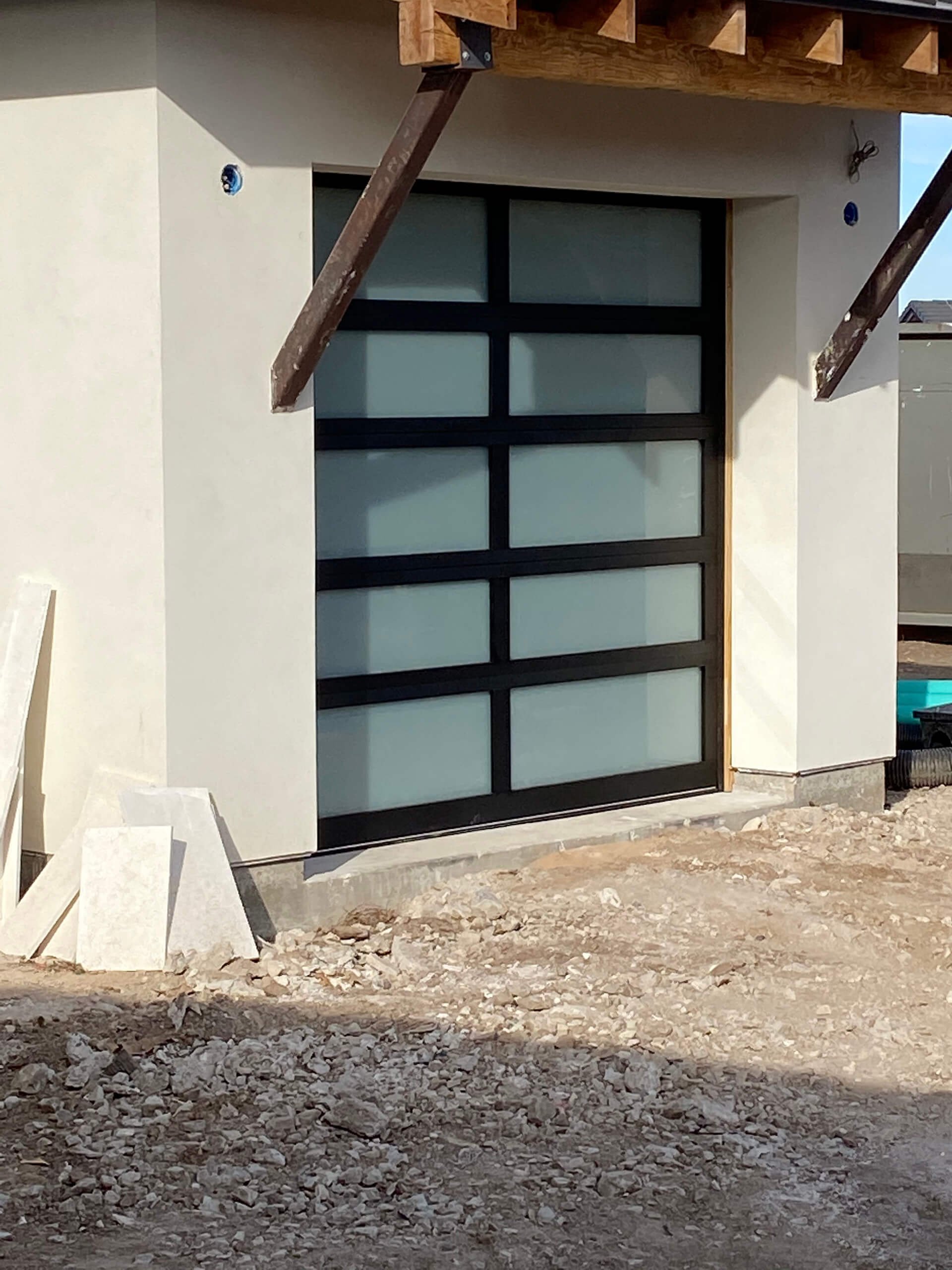 Triple wood carriage-style garage doors installed by Door Pro Plus on a Texas Hill Country home