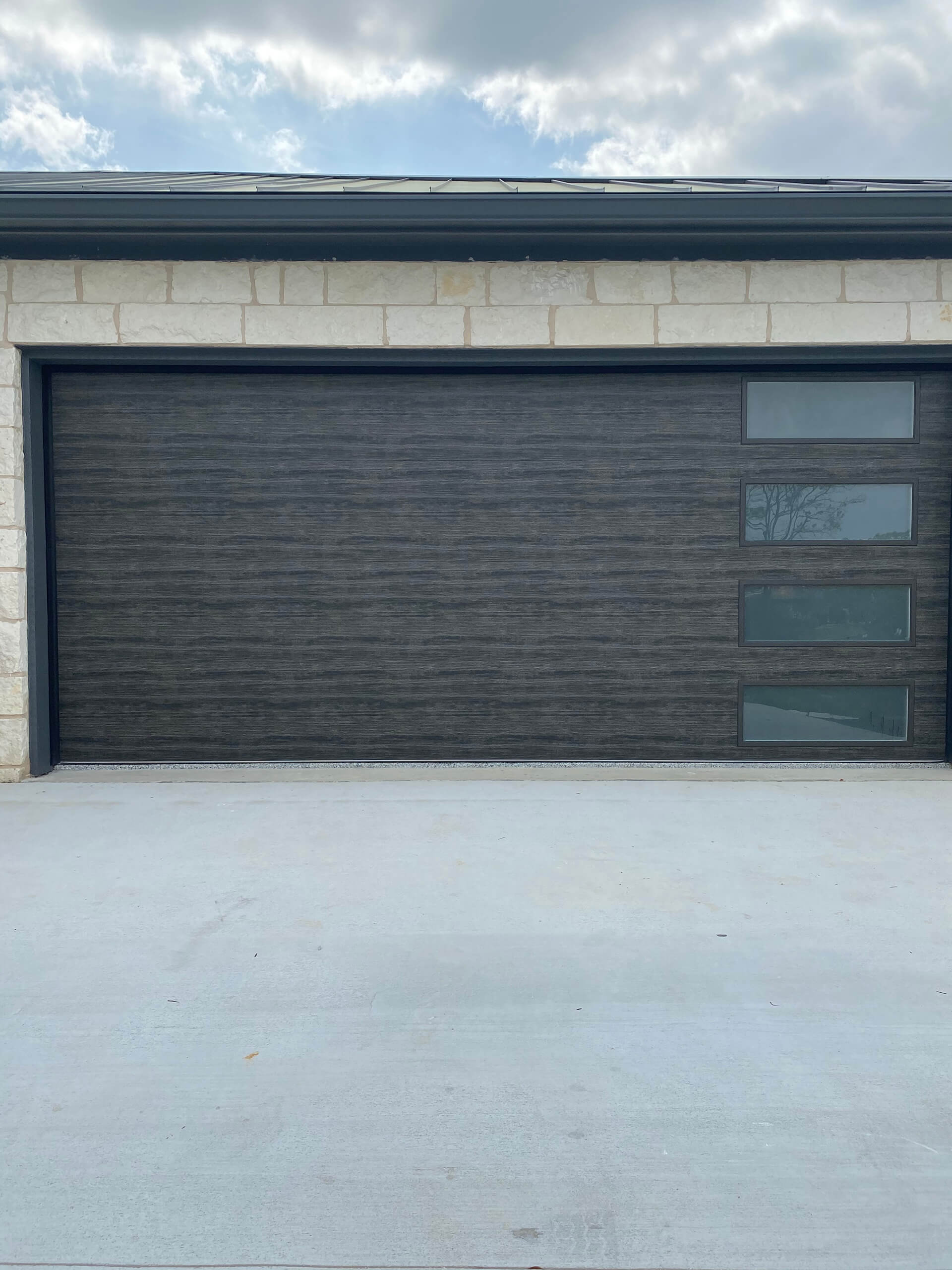Garage door with newly serviced springs and hardware, repaired by Door Pro Plus near Marble Falls, TX