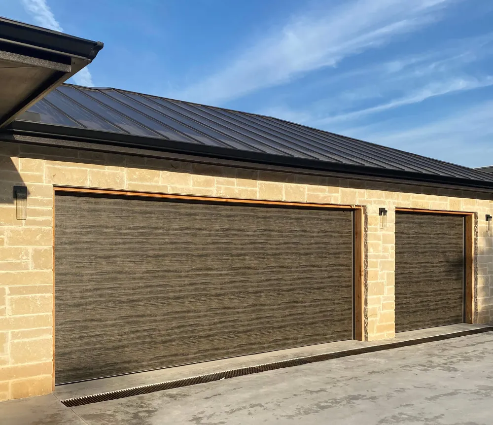 Two-car garage door with a professionally installed opener system, serviced by Door Pro Plus in the Texas Hill Country